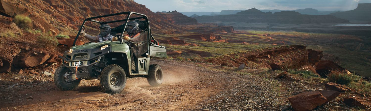 Man riding a 2016 Polaris® Ranger® UTV through the rocky foothills